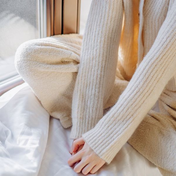 A cozy armchair next to a window with soft morning light.